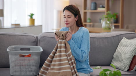 woman folding clothes in living room