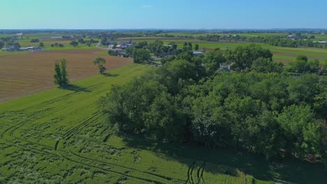 an aerial view of rural pennsylvania, with farms, trees and homes on a sunny spring day