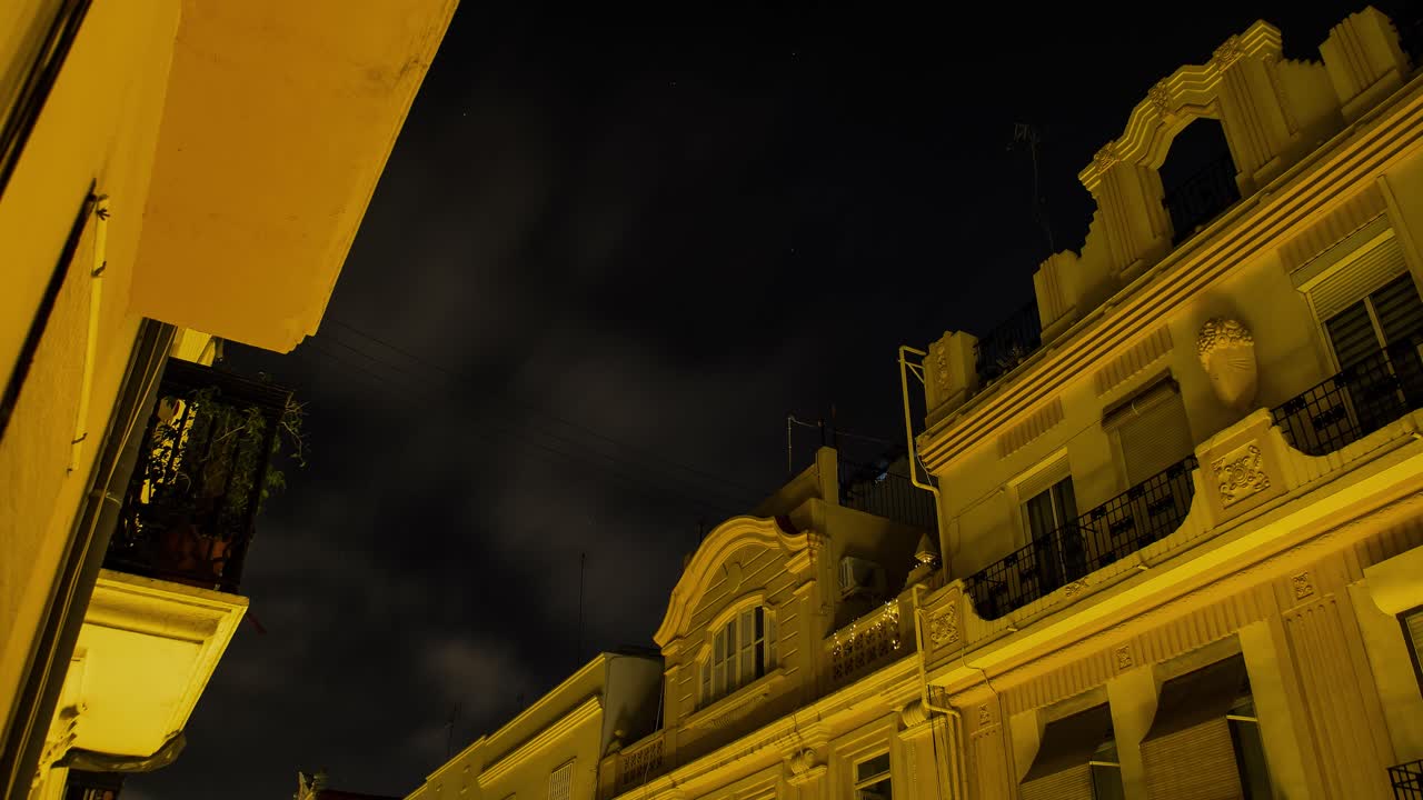 закат с темными облаками, дым от костра, а затем начинается, снято с балкона в центре валенсии, золотые здания с драматическим небом.