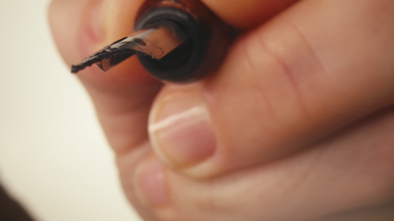Close-up of Hand Writing 'Peace' with a Fountain Pen