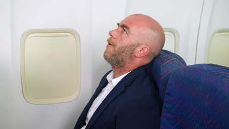 Frustrated-business-man-on-a-passenger-airliner-plane-waiting-for-take-off