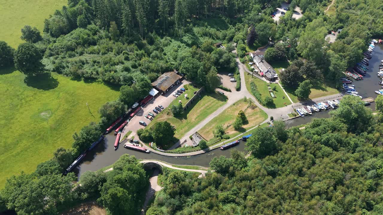 Scenic Welsh countryside with a historic canal wharf and boats seen from above