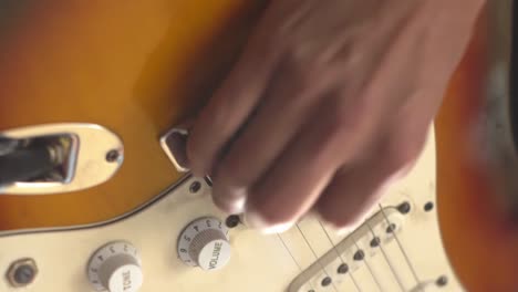 person playing an electric guitar. vertical detail shot