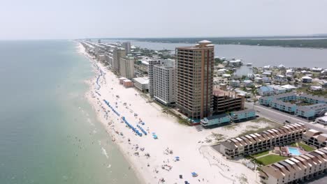 Gulf-Shores,-Alabama-skyline-and-beach-with-drone-video-pulling-back