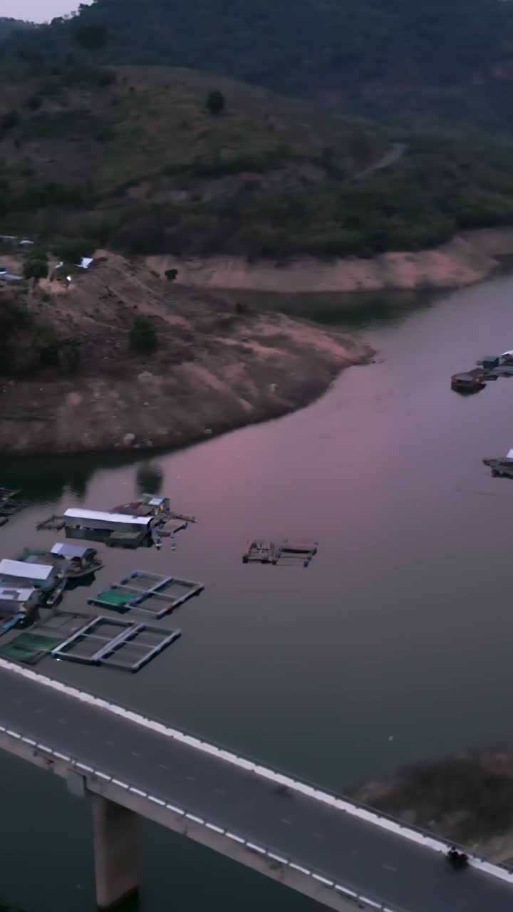 Aerial view of a lake with houses and a bridge