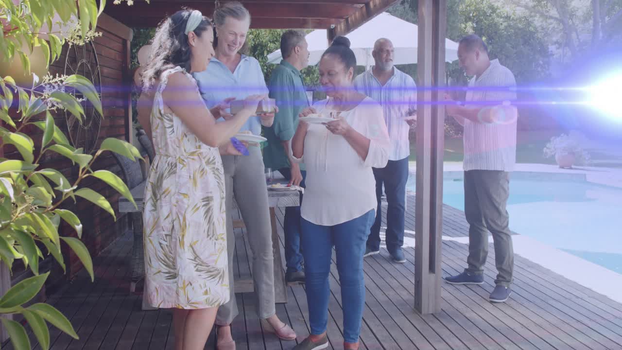 Woman showing gift on pool deck, women reading card, guests tasting dessert, celebrating event