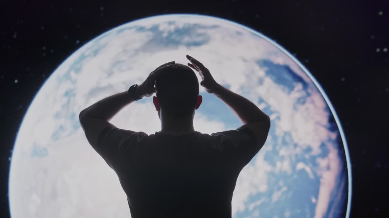 Man looking at Earth from space with hands on head