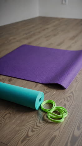 yoga mat and accessories on a wooden floor