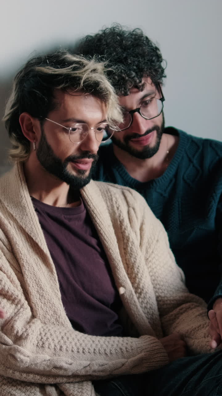 Gay Couple Enjoys Coffee and Laptop at Home