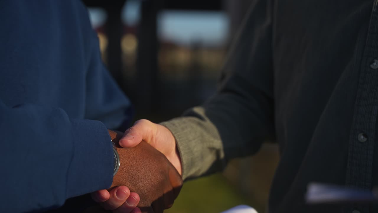 A handshake between two people signifying a business agreement