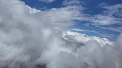 pov flying free through some cottony clouds doing a left turn under a deep blue sky. aerial shot taken from a jet cockpit. ultra-realistic 4k