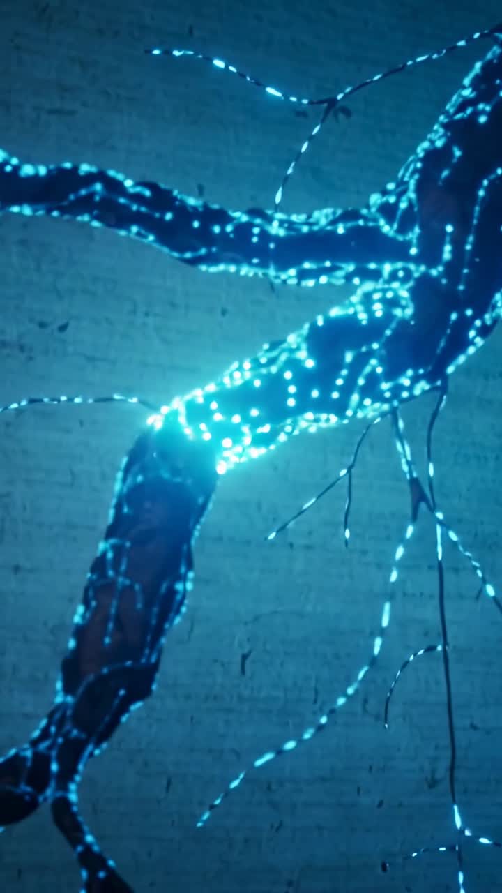Vertical video: Camera shifting, glowing tendril displaying migrating cyan nodes along brick wall