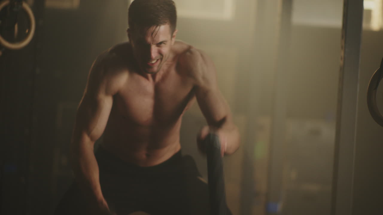 Man performing a rope workout in a gym