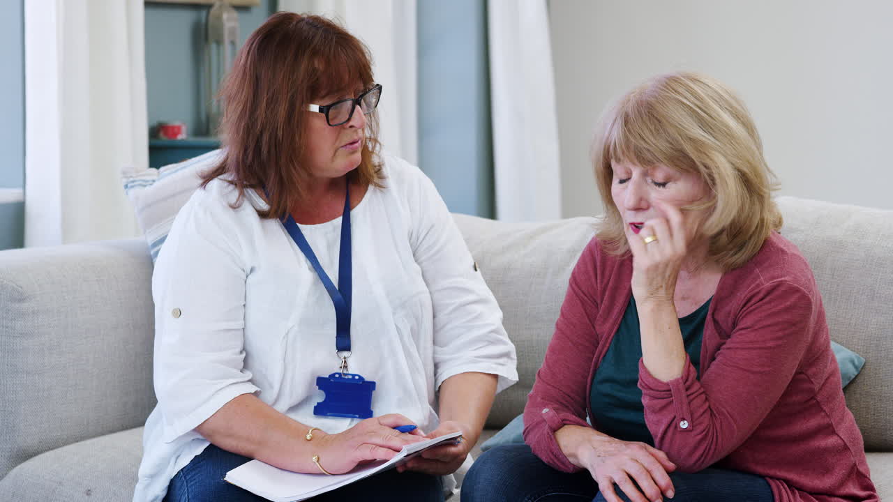 Support Worker Visits Senior Woman Suffering With Depression
