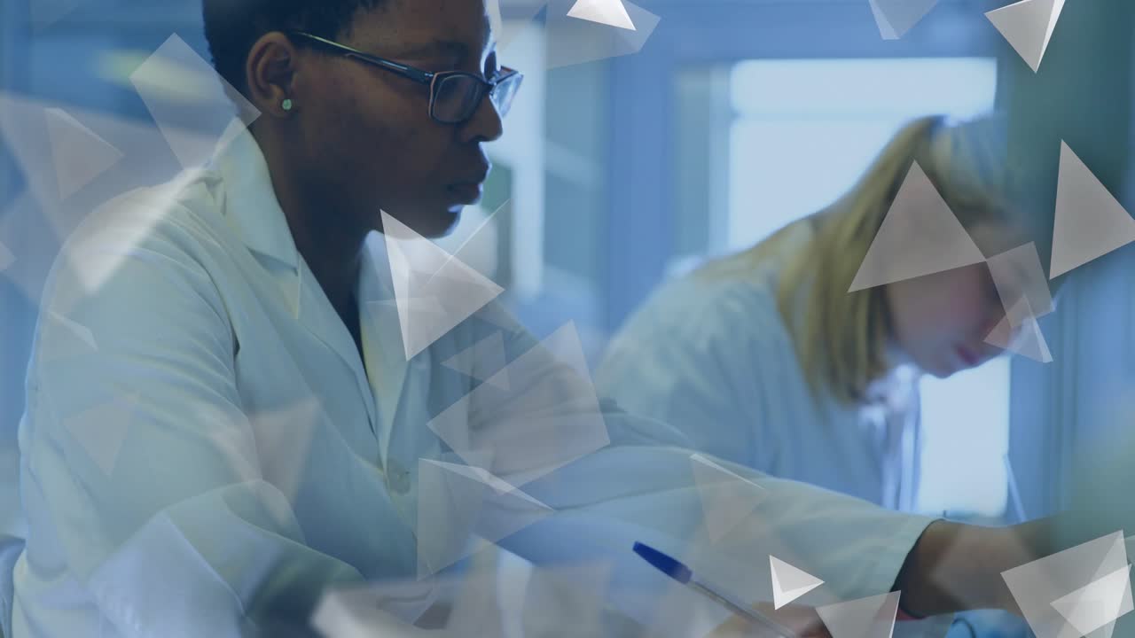 Lead student shifting from notes to inspecting green solution for lab, triangle overlay drifting