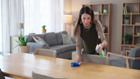 woman cleaning a wooden table with a spray bottle