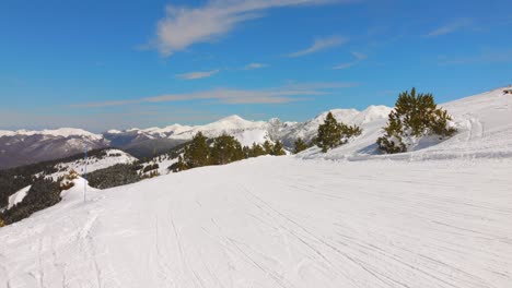 deep snow-covered landscape with pyrenees mountain range at ax 3 domaines ski resort in ax-les-thermes, france. aerial shot