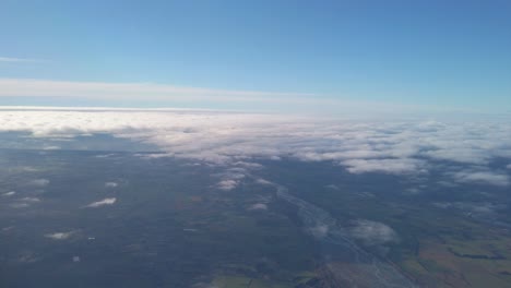 aerial shot over a river surrounded by farmland