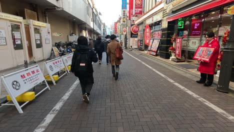 promoter holding sign as pedestrians pass by