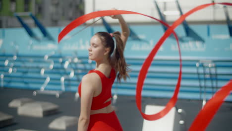 woman performing ribbon dance outdoors