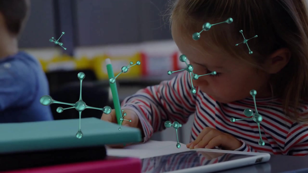 Girl leaning in writing in class causing molecular shapes floating around green pencil