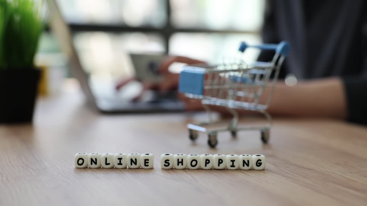 Online Shopping Concept with Laptop and Mini Shopping Cart