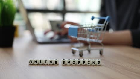 online shopping concept with laptop and mini shopping cart