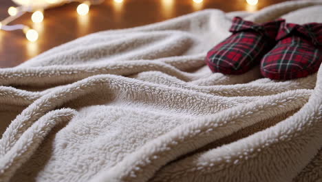 christmas plaid slippers on a cozy blanket