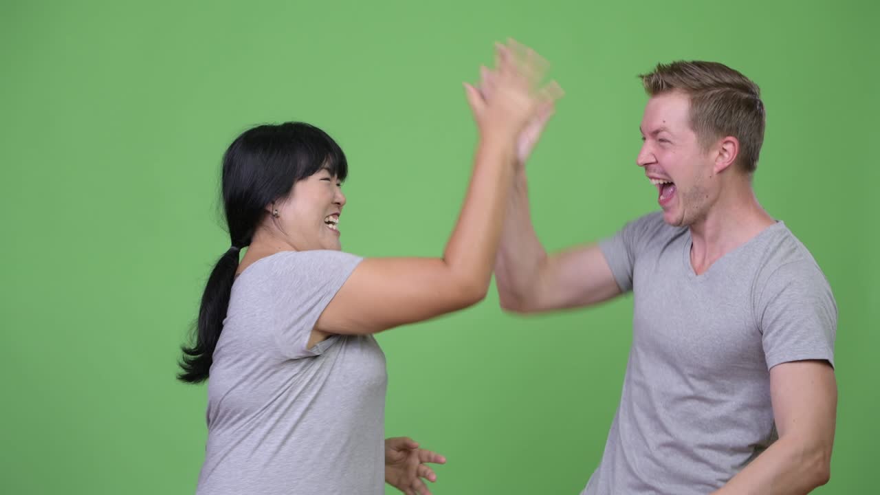 Young multi-ethnic couple looking excited together