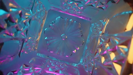 wide angle macro inside a spinning crystal carafe under color-changing lights, probe lens