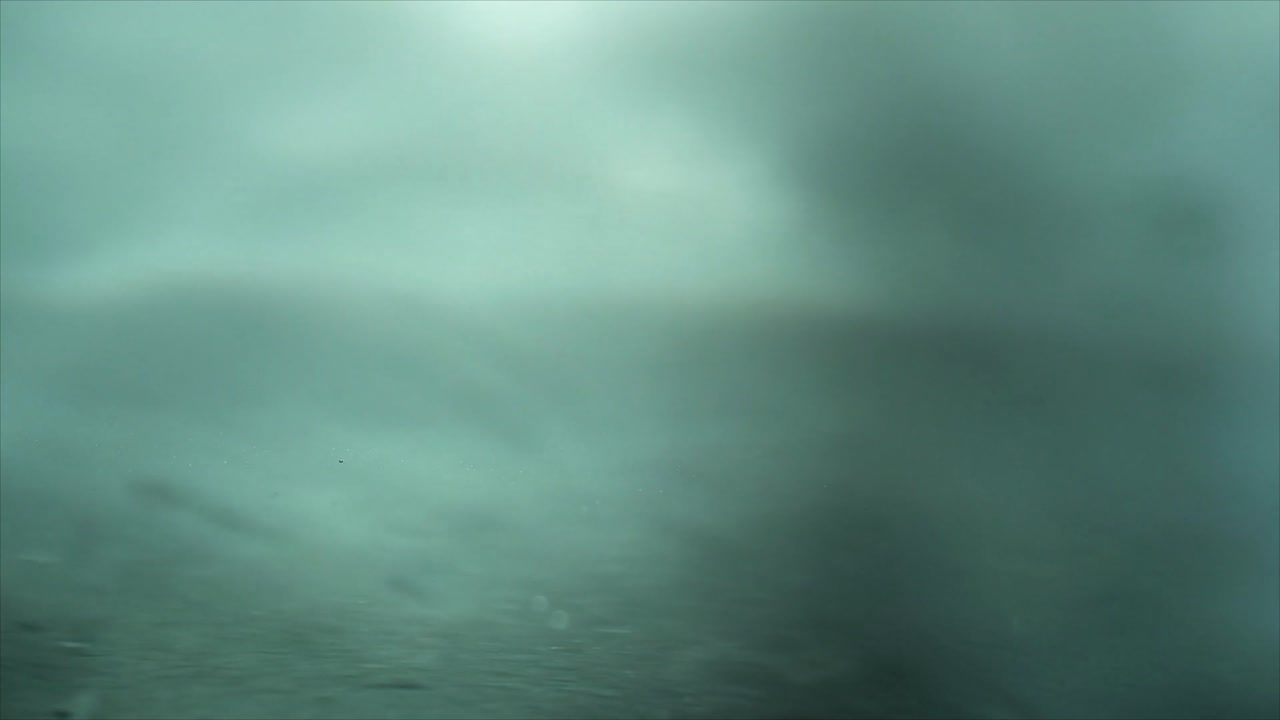 Slow Motion Water Drops Creating Ripples and Splashes on Liquid Surface