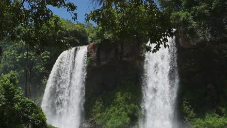 Iguazu-Falls-Waterfall-in-Brazil,-Hiding-in-Tall-Beautiful-Jungle-Landscape,-Overhanging-Rocky-Cliff-with-Waterfall-Falling-into-Hidden-Pool-Below,-Amazing-Scenic-Views-in-Iguacu-Falls,-South-America