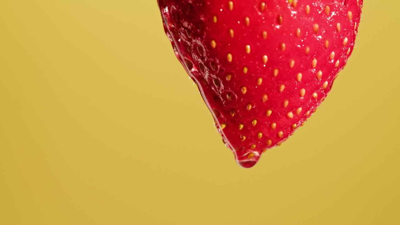 Close-up of a single, wet strawberry