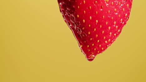 close-up of a single, wet strawberry