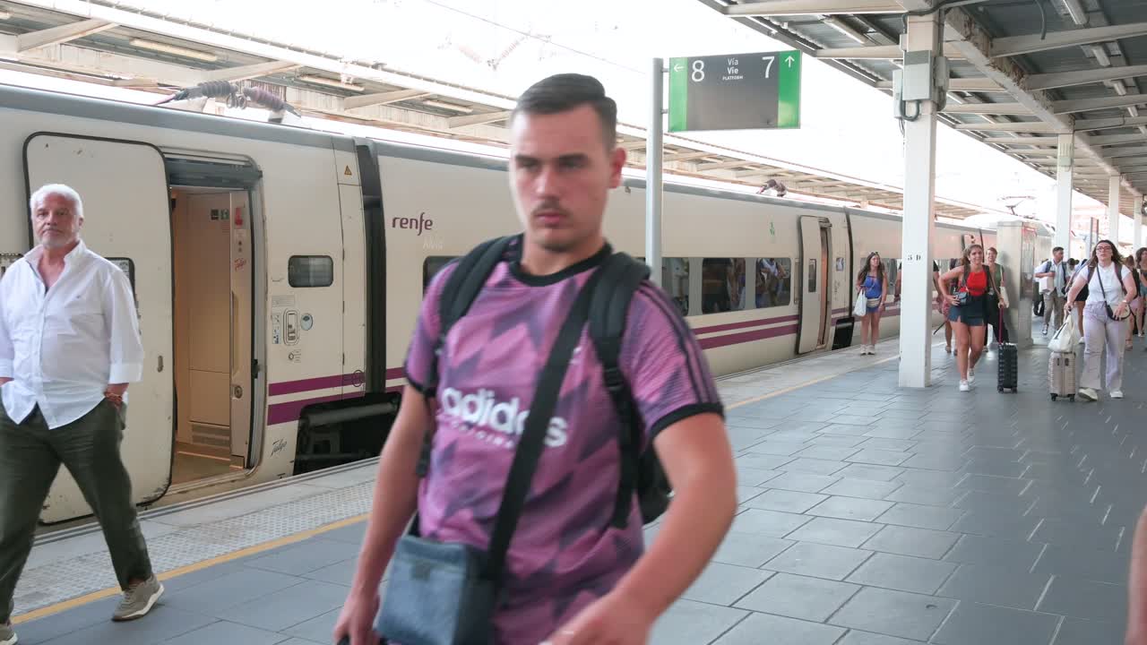 Passengers disembark from a train operated by Renfe, Spain's national state-owned railway company, as they arrive at Joaquin Sorolla train station in Valencia, Spain.