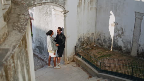 couple walking through an old town