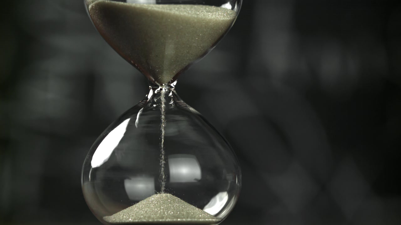 Hourglass with Sand Flowing, Symbolizing Passing Time