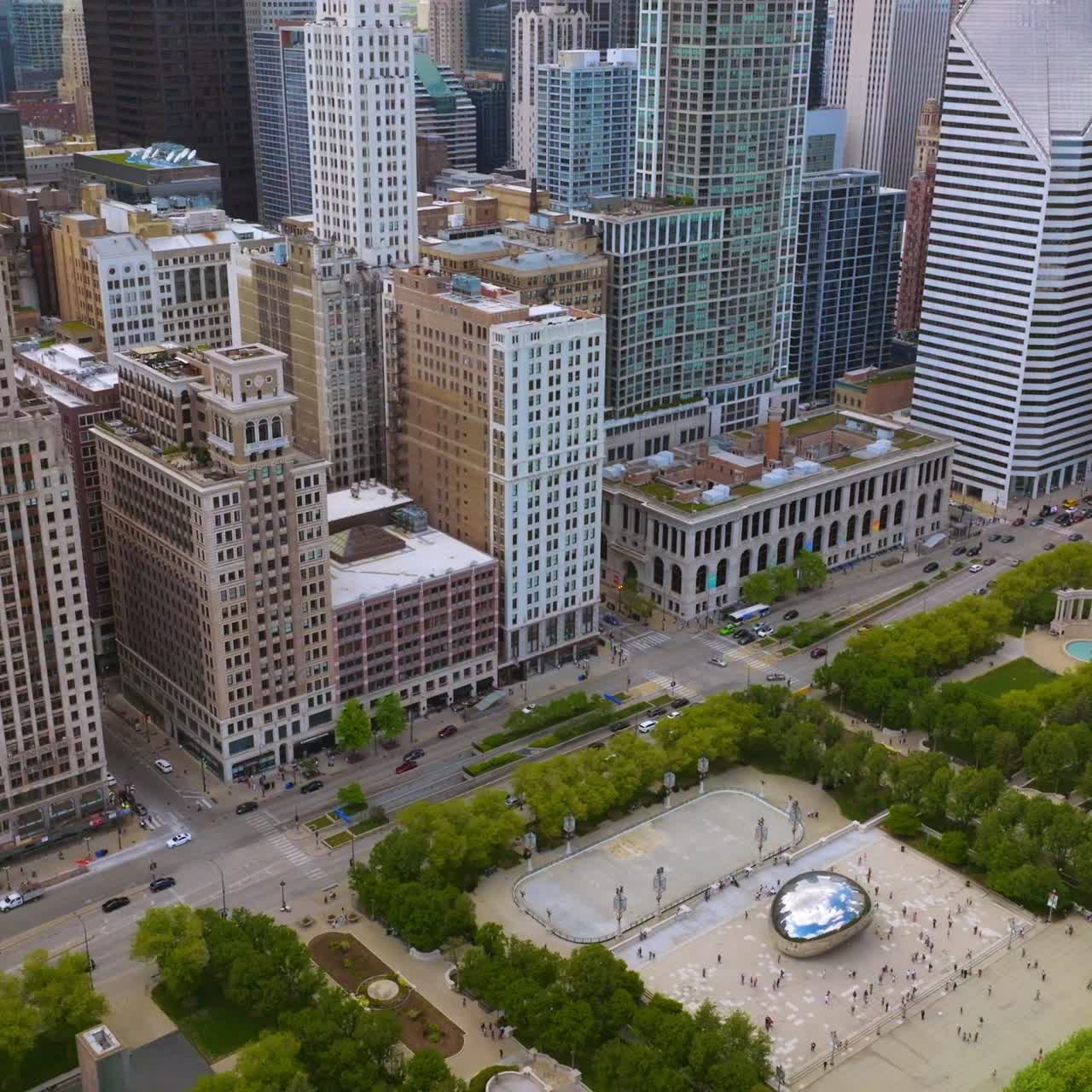Fantastic Millennium Park with Cloud Gate sculpture. Wonderful Chicago architecture surrounding green area