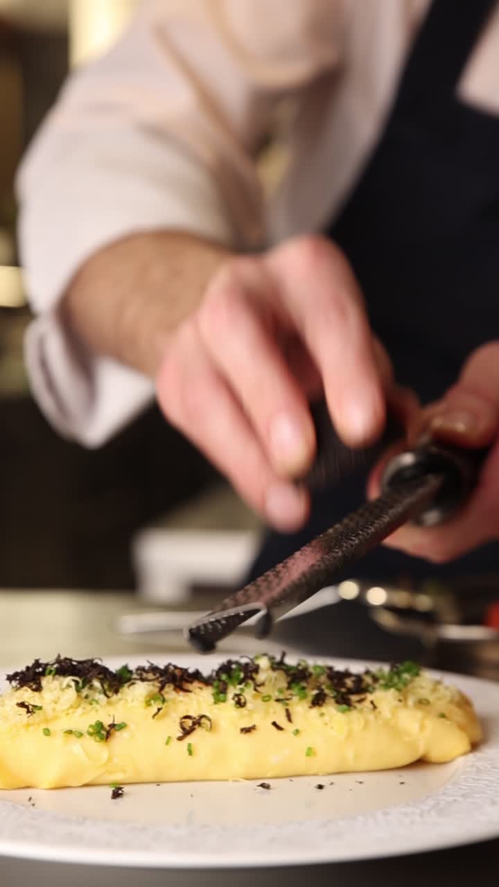 Chef Grating Fresh Black Truffle Over a Gourmet Omelet