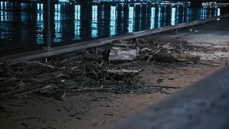 debris scattered on a riverside walkway after a nighttime flood in budapest, hungary