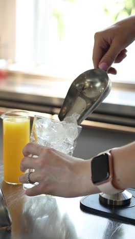 pouring ice into a glass