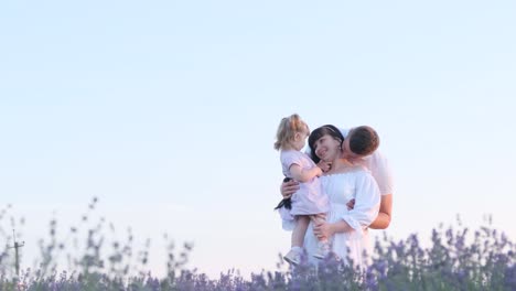 a stylish young family with a child walks on a lavender field enjoy the moments together a stylish young family with a child walks on a lavender field a handsome man holds the hand of a beautiful brunette woman enjoy the moments together meeting the sunset high quality video