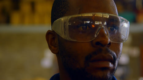 worker standing in protective eyewear in foundry workshop 4k