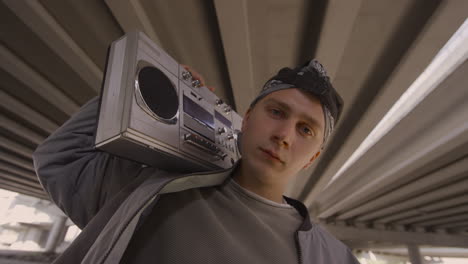 young man posing with stereo