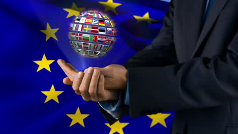 ball made of european nationals flags turning on hands in front of european flag