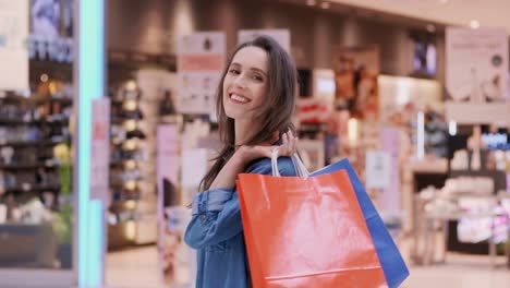 waist up of turning woman with shopping bags