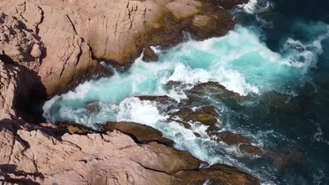 Waves-crashing-in-to-the-cliffs-and-rocks-of-Santa-Maria-Beach-in-Cabo-San-Lucas,-Mexico,-slow-motion