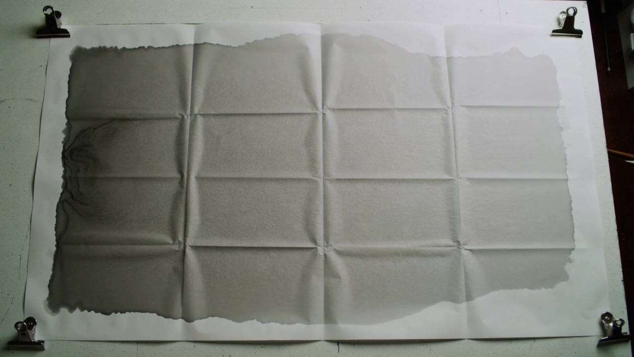 Frames advancing large sheet 4x4 crease grid slowly deepening gray wash on bench, binder clips