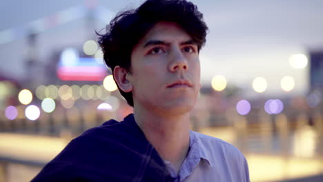 portrait of a man in front of a ferris wheel