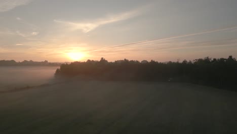 sunrise over misty farmland